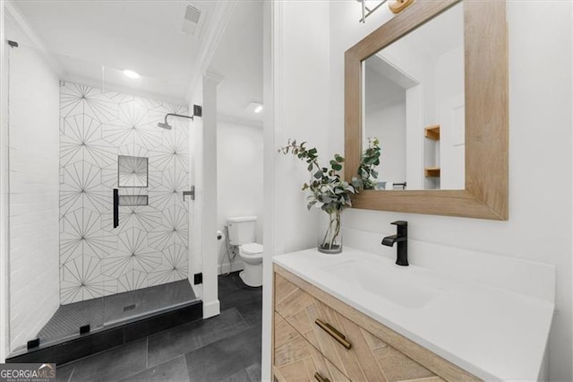bathroom with vanity, ornamental molding, a shower stall, and toilet
