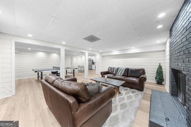 living area featuring a fireplace and light wood-type flooring