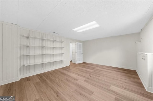 unfurnished living room featuring baseboards and wood finished floors