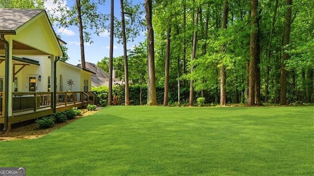 view of yard with a wooden deck