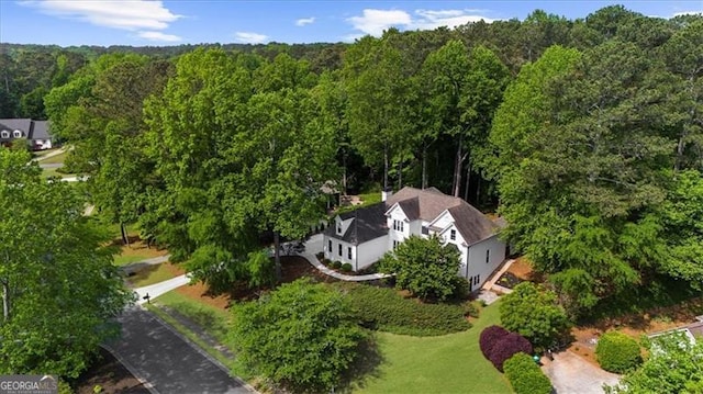 drone / aerial view with a wooded view