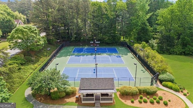 view of tennis court featuring fence