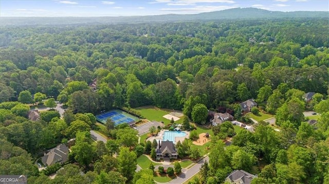 birds eye view of property featuring a wooded view