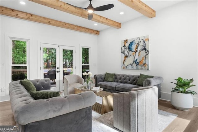 living room featuring french doors, light wood-style flooring, a healthy amount of sunlight, and beamed ceiling