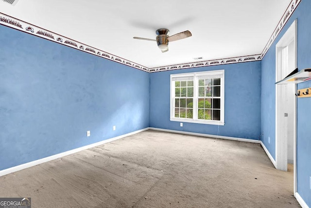 spare room with carpet flooring, ceiling fan, and baseboards