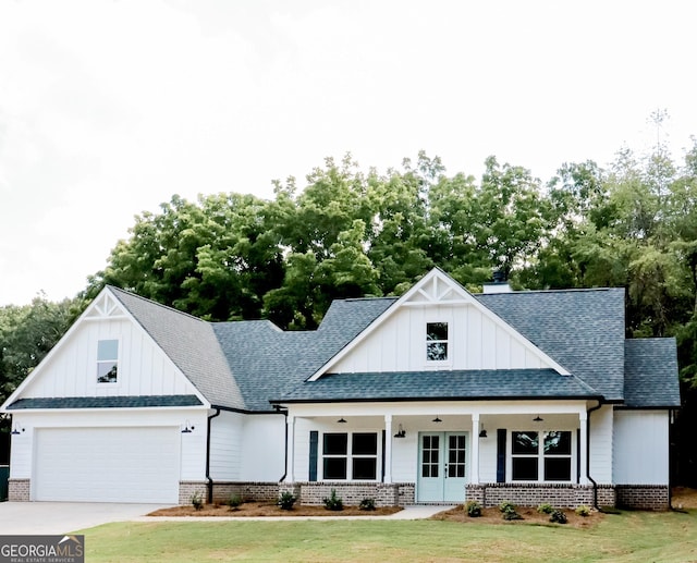 modern farmhouse style home featuring a front lawn, roof with shingles, and french doors