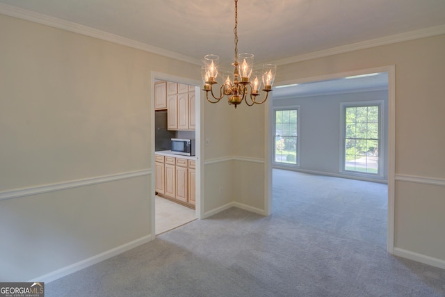 unfurnished dining area with an inviting chandelier, baseboards, crown molding, and light carpet