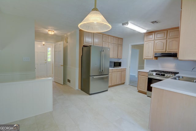 kitchen featuring a sink, appliances with stainless steel finishes, light brown cabinetry, and exhaust hood