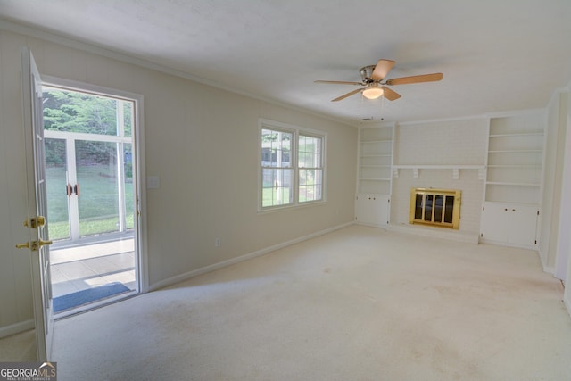 unfurnished living room with a ceiling fan, baseboards, ornamental molding, and a healthy amount of sunlight