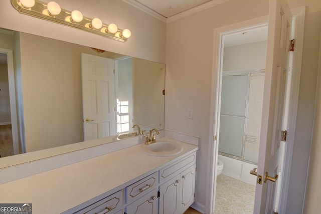 bathroom featuring vanity, ornamental molding, enclosed tub / shower combo, and toilet