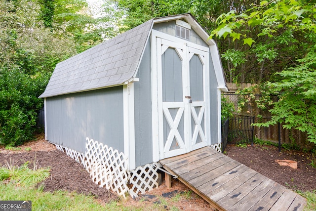 view of shed with fence