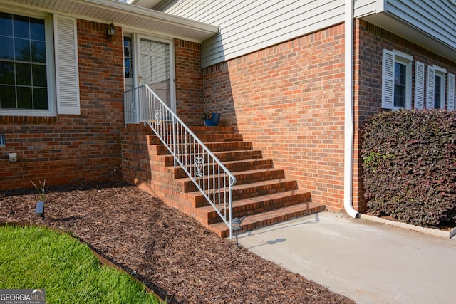 property entrance featuring brick siding