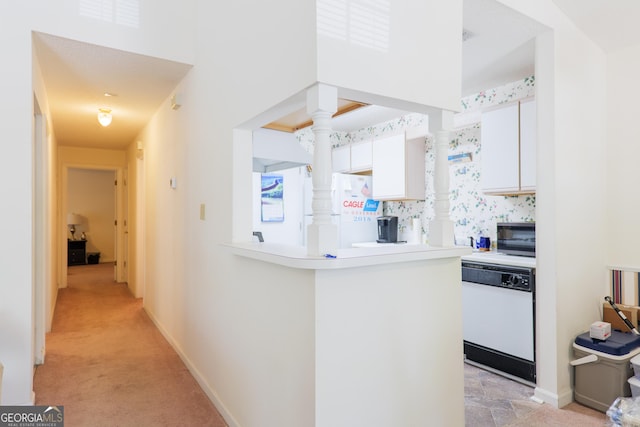 1921 Gornto Rd Unit 10, Valdosta, GA 31602 - kitchen with visible vents, a peninsula, white appliances, light countertops, and white cabinets