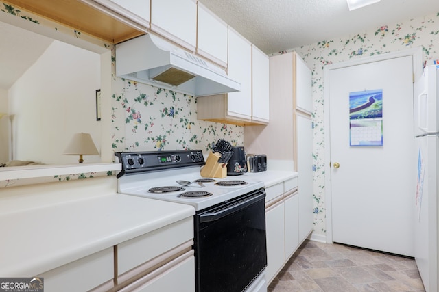 1921 Gornto Rd Unit 10, Valdosta, GA 31602 - kitchen with wallpapered walls, light countertops, under cabinet range hood, white cabinets, and electric stove