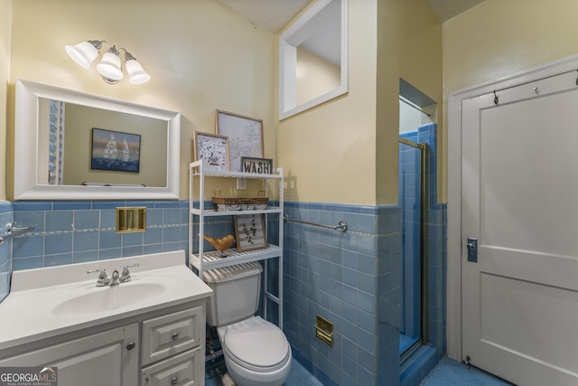 603 Piney Woods Dr, Lagrange, GA 30240 - bathroom with tile walls, wainscoting, a stall shower, vanity, and toilet