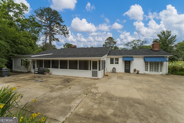 603 Piney Woods Dr, Lagrange, GA 30240 - back of property with a sunroom, a shingled roof, and a chimney
