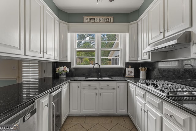 603 Piney Woods Dr, Lagrange, GA 30240 - kitchen with under cabinet range hood, white cabinetry, a sink, and wine cooler