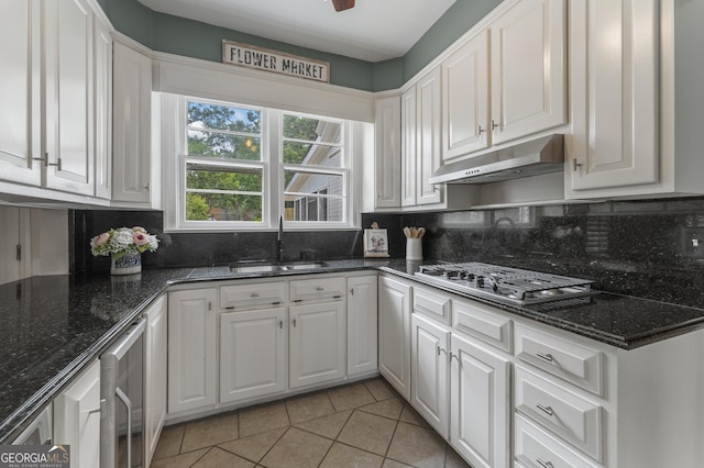 603 Piney Woods Dr, Lagrange, GA 30240 - kitchen featuring under cabinet range hood, stainless steel gas stovetop, white cabinets, and a sink