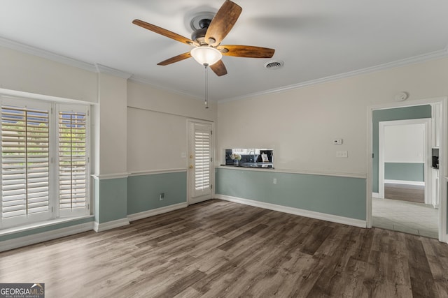 603 Piney Woods Dr, Lagrange, GA 30240 - spare room featuring visible vents, crown molding, wood finished floors, and ceiling fan