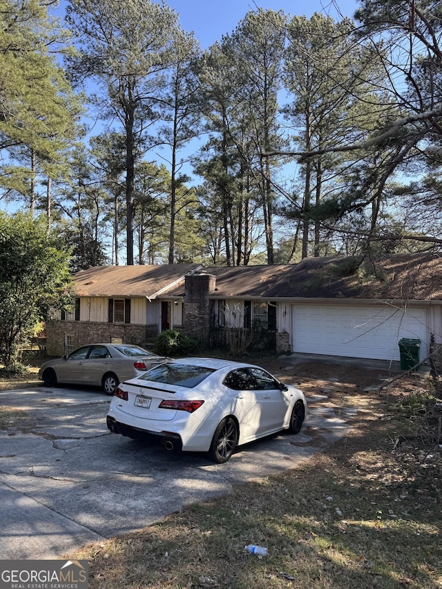view of front facade featuring a garage, board and batten siding, and driveway