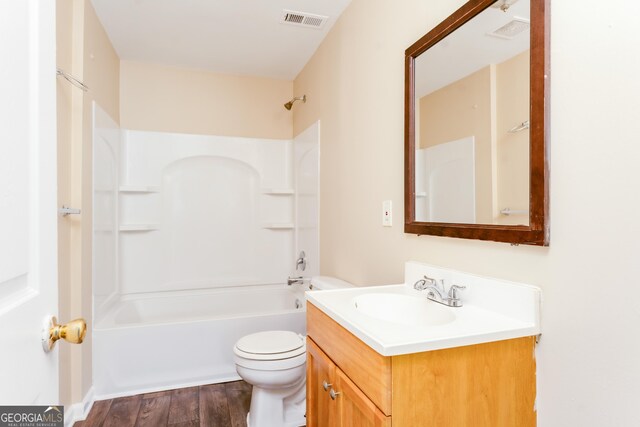 2497 Lakewood Ave SW, Atlanta, GA 30315 - full bath featuring visible vents, vanity, tub / shower combination, wood finished floors, and toilet