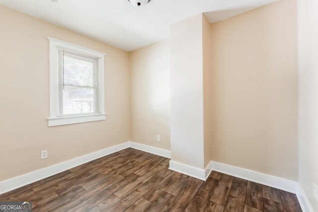 2497 Lakewood Ave SW, Atlanta, GA 30315 - unfurnished room featuring baseboards and dark wood-style floors