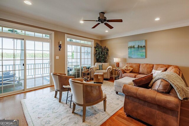 living area featuring crown molding, a ceiling fan, recessed lighting, and light wood-type flooring