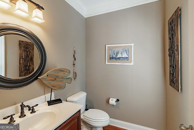 bathroom featuring crown molding, baseboards, toilet, and vanity