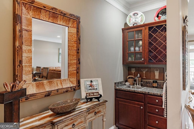 bar with a sink, ornamental molding, and backsplash