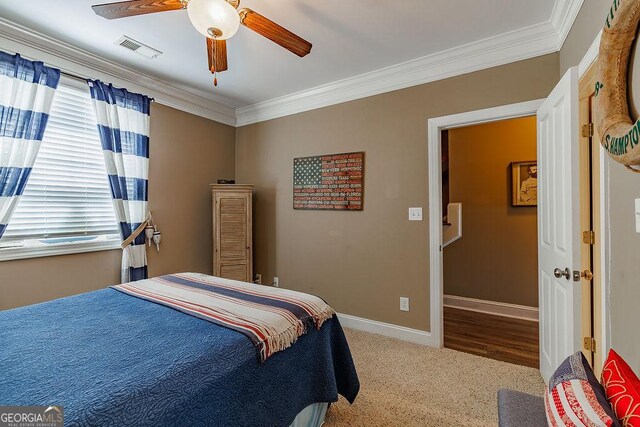 dining room featuring crown molding, baseboards, and wood finished floors