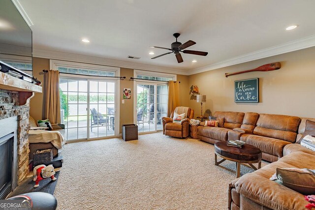 living area featuring ceiling fan, a stone fireplace, crown molding, baseboards, and recessed lighting