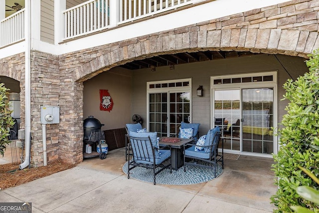 view of patio featuring a balcony