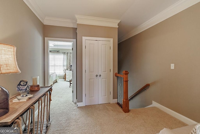 hallway featuring carpet floors, crown molding, an upstairs landing, and baseboards