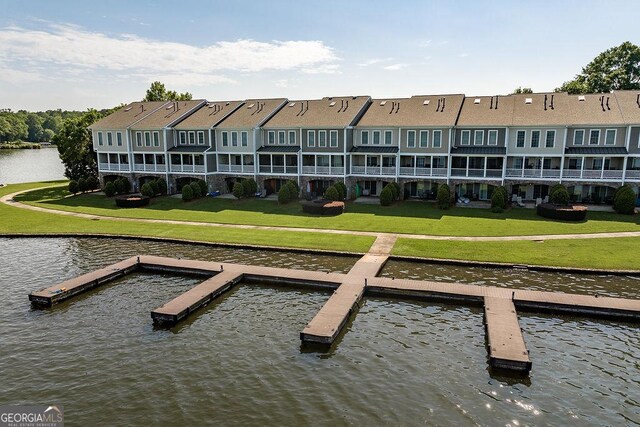 exterior space featuring a lawn and a water view