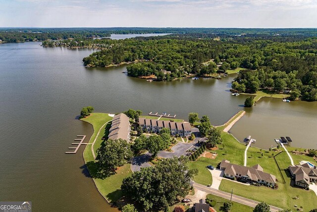 aerial view with a water view and a forest view