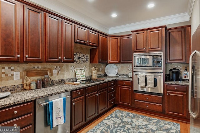 kitchen featuring stone countertops, ornamental molding, light wood-style flooring, and appliances with stainless steel finishes