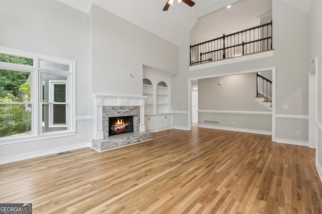 110 Keswick Way, Alpharetta, GA 30022 - unfurnished living room featuring stairs, a fireplace, ceiling fan, high vaulted ceiling, and built in shelves