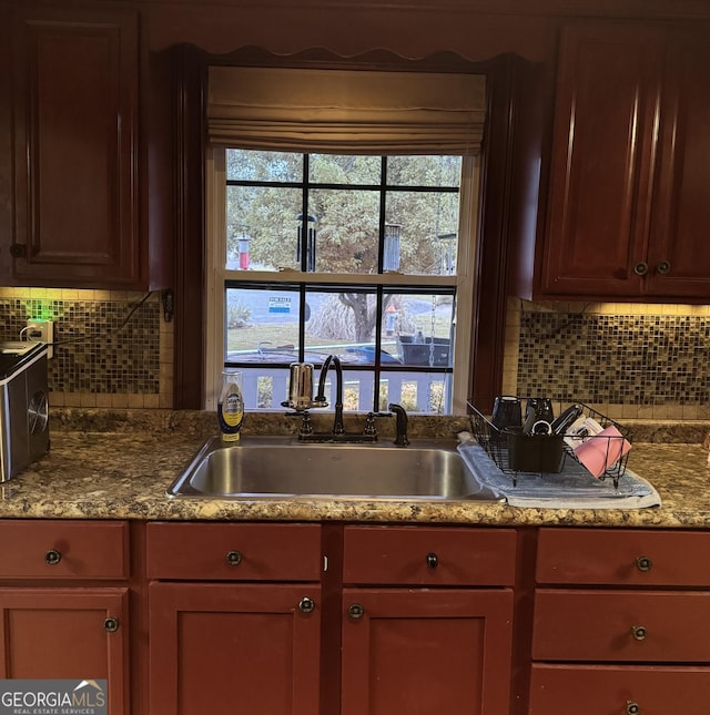 kitchen with decorative backsplash and a sink