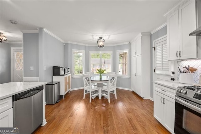 kitchen with light wood-type flooring, white cabinetry, tasteful backsplash, light stone counters, and stainless steel appliances