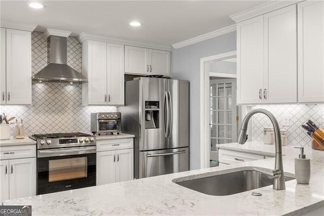 kitchen featuring light stone countertops, wall chimney exhaust hood, tasteful backsplash, a sink, and stainless steel appliances