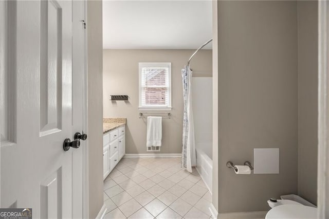 bathroom featuring vanity, shower / tub combo with curtain, toilet, baseboards, and tile patterned floors