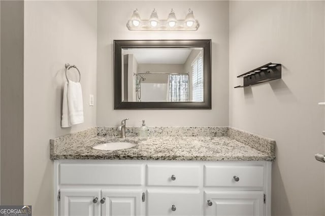 bathroom featuring vanity and a shower with shower curtain