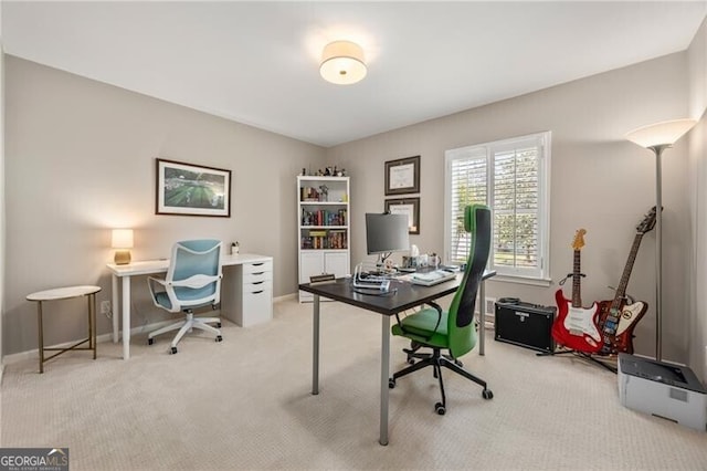 home office with baseboards and light colored carpet