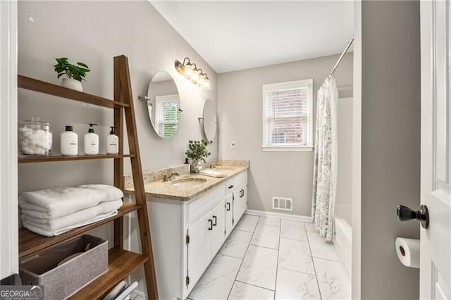 full bathroom with double vanity, visible vents, a sink, baseboards, and marble finish floor
