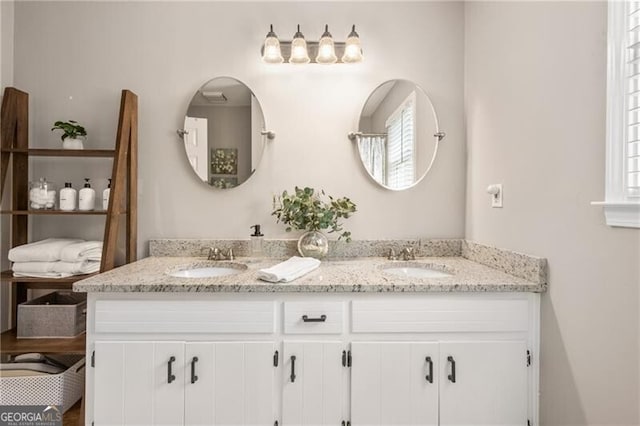 full bathroom with a sink and double vanity