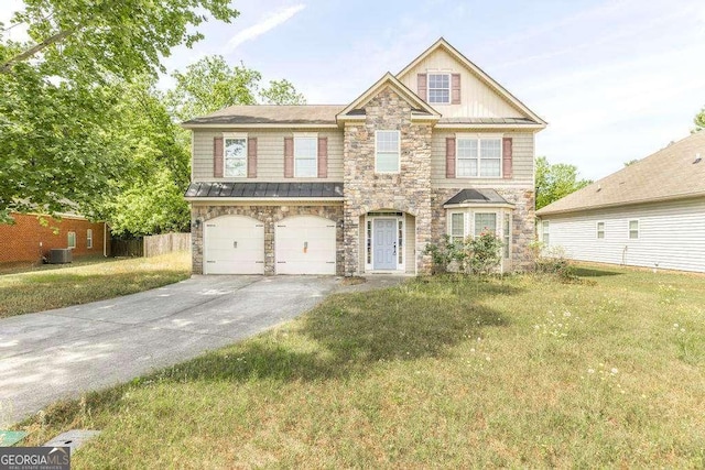 view of front of house with a front lawn, stone siding, cooling unit, an attached garage, and driveway