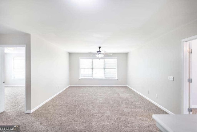 unfurnished living room with baseboards, ceiling fan, and carpet flooring