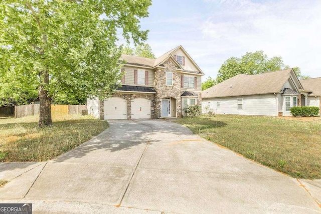traditional-style home featuring a garage, a front lawn, fence, stone siding, and concrete driveway