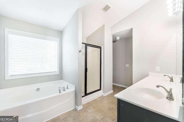 bathroom with a bath, visible vents, a shower stall, a sink, and baseboards