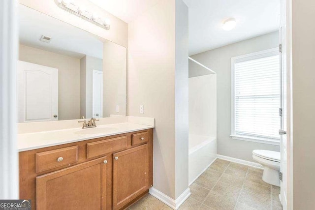 bathroom featuring toilet, baseboards, shower / bath combination, and vanity